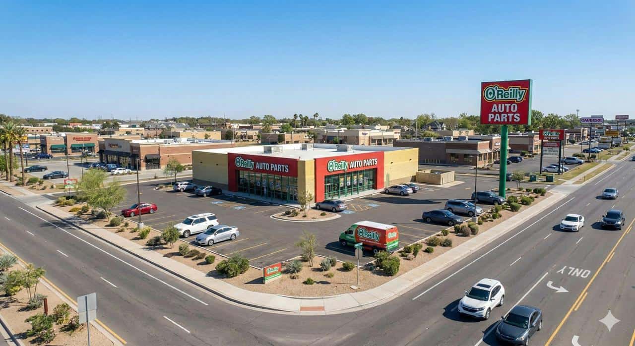 O'Reilly Auto Parts freestanding store on suburban arterial road showing high-visibility pylon sign dedicated parking and commercial delivery access