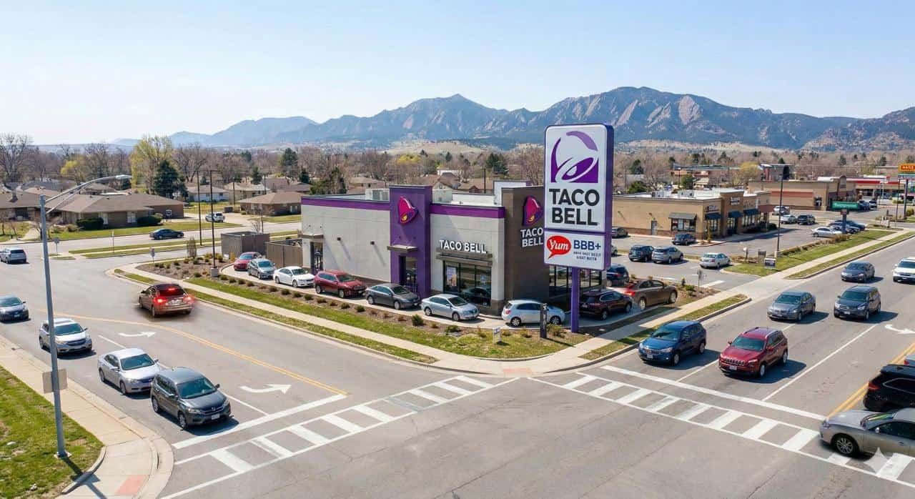 Taco Bell NNN investment property in Denver Colorado showing freestanding restaurant with double-lane drive-thru configuration on 40000 vehicle per day suburban arterial corridor